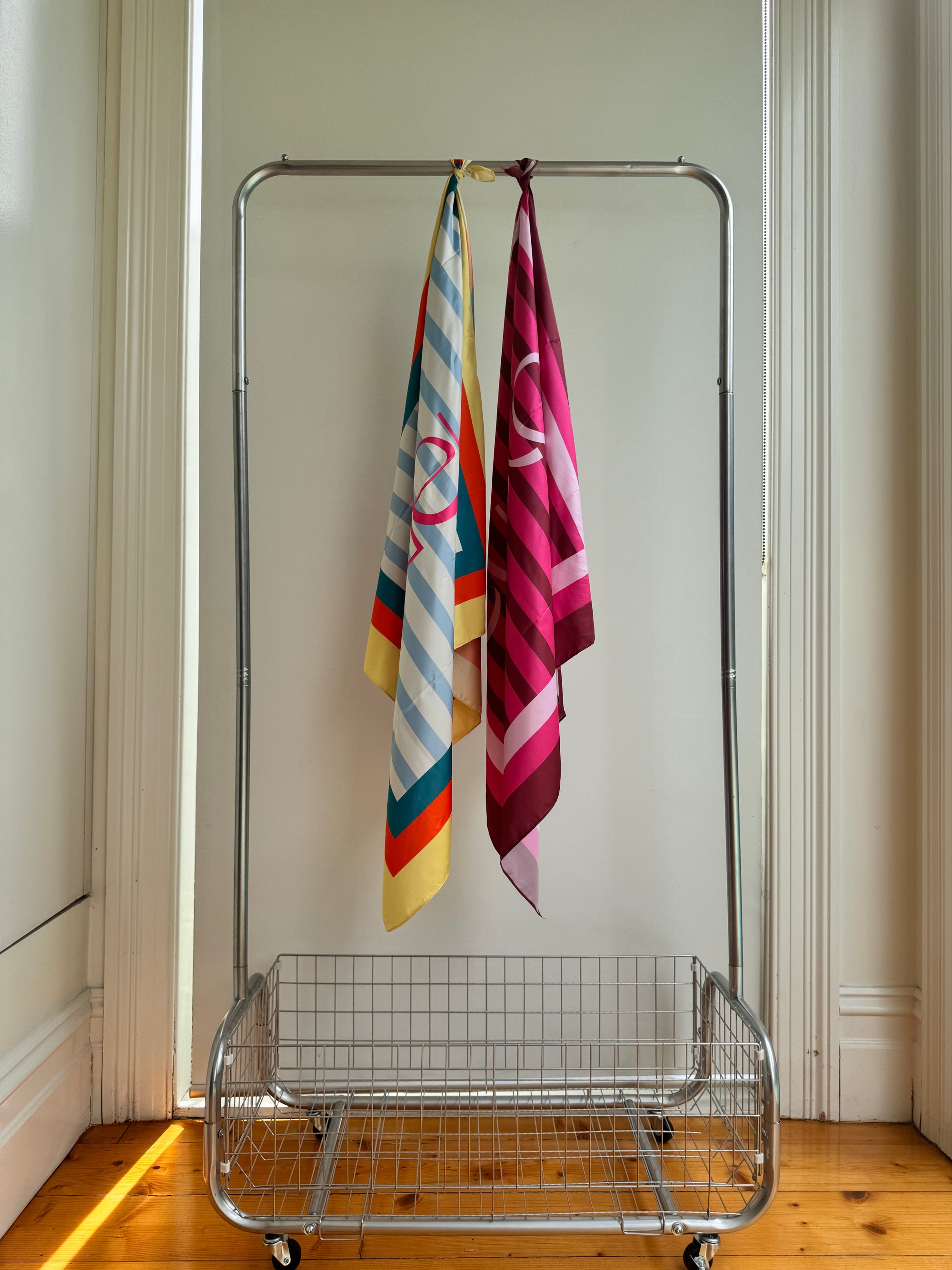 Australian-designed pink scarf with bright stripe pattern